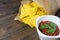 Nachos corn chips with classic tomato salsa. Fresh cold beer is perfect with savory snacks.