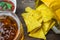 Nachos corn chips with classic tomato salsa. Fresh cold beer is perfect with savory snacks.