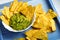 Nachos corn chips with guacamole sauce close up photo