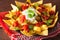 Nachos loaded with salsa, cheese and jalapeno