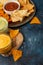 Nachos tortilla chips with salsa and cheese dip on the wooden board isolated on dark blue background. Corn chips with souses. Food