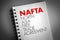 NAFTA - North Asia Free Trade Agreement acronym on notepad, business concept background