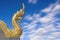 Naga at buddhism temple in smooth clouds blue sky