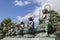 Nagano - Japan, June 3, 2017: Six bronze Buddha statues with red