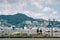 Nagasaki, Kyushu, Japan, East Asia - Students going home after school in a background of beautiful landscape with sea and mountain