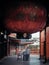 Nagoya, Aichi, Japan - An old man having a worship ceremony under the giant red Japanese lantern in Osu Kannon.