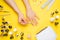 Nail art in the luxurious beauty salon. Gel for modeling nails. A woman receives a manicure by a beautician. On a yellow