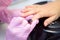 Nail Care And Manicure concept. Closeup Manicurist hands in pink gloves is Painting black Nail Polish On Client`s Nails. Woman In