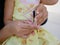 A nail clippers in mother`s hand trimming her baby girl`s fingernails - cutting baby`s nails