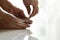 Nail clipping, senior woman foot cutting nails using nail clipper on white background, closeup