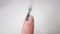 Nail close-up. Use a brush to apply a clear varnish on the nail plate. Applying vitamin enamel to the nail. Manicure