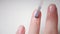 Nail close-up. Use a brush to apply a clear varnish on the nail plate. Applying vitamin enamel to the nail. Manicure