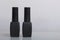 Nail coating with gel-varnish. Gel-lacquer in black bottles stands on a white surface.