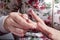 Nail coating with gel-varnish. A woman is applying a nail polish on her nails.