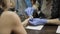 Nail filing and hand care. Woman hands receiving a manicure in beauty salon.