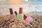Nail polish bottles on a sea pebbles. Summer varnish