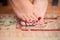 Nail polish on woman feet with fresh red pedicure stand on carpet