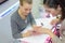 Nail salon worker giving manicure to customer