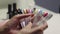 nail service master in beauty salon makes manicurist to client selects the color of varnish