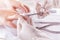 Nail technician giving customer a manicure at nail salon. Young caucasian woman receiving a french manicure. Closeup shot of a