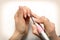 Nails Beauty. Closeup Of Woman Hands Receiving Nail Care Treatment.Manicurist Hands Cutting Cuticle On Nails With Nail Clippers