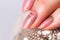 Nails Design. Hands With Bright Nude Manicure On Grey Background. Close Up Of Female Hands. Art Nail