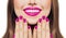 Nails and lips. Woman touching her cheeks her hands with manicure nails. Pink color lipstick and nail polish