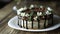 Naked drip cake with chocolate, decorated with strawberries, jasmine flowers and honeysuckle on brown wooden table