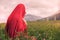 Naked female in a red scarf in a field at sunset