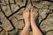 Naked human barefeet on dry soil