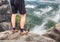 Naked legs of successful hiker on exposed sandstone rock