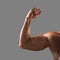 Naked muscular male hand showing pumped biceps. Close up shot. Male beauty concept.  on a gray background