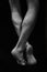 Naked muscular male legs on a black background