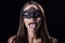 Naked scary vampire girl in masquerade mask with fangs showing fangs
