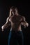 Naked torso male bodybuilder athlete with long blond hair in studio