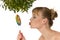 Naked woman kissing a lollipop under mistletoe