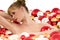 Naked woman lying in bath with Christmas balls