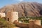 Nakhal Fort and oasis of date palms under the mountain