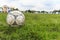Nakhon Ratchasima, Thailand - October 1 : Muddy soccer ball on a football field in Municipal Stadium Nakhon Ratchasima on October