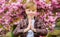 Namaste concept. Peaceful child enjoy warm spring day. Sakura garden. Child pink flowers of sakura tree background. Guy