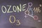 name, chemical formula and structure diagram of Ozone handwritten on blackboard with colorful chalk.