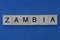 name of the country of zambia from the word from gray wooden letters