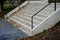 Name gray monolithic concrete park bench made of concrete in the shape of round stones wooden staircase bench with staircase light