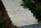 Name gray monolithic concrete park bench made of concrete in the shape of round stones wooden staircase bench with staircase light