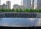 Name inscription of victims victim inscribed on bronze parapets on Ground Zero 9/11 Memorial Pool surrounded by visitors