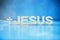 Name JESUS made with cement letters on blue light marble background. Copy space. Biblical, spiritual or christian