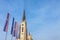 The Name of Mary Church, also known as Novi Sad catholic cathedral on a sunny afternoon with the flags of Voivodina province