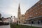 The Name of Mary Church, or Novi Sad catholic cathedral on a cloudy afternoon with a crowd walking on Trg Slobode Square.