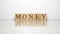 The name Money was created from wooden letter cubes. finance and economy.