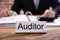 Nameplate With Auditor Title Kept On Desk